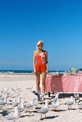 model ayla wearing coke x svs pants at beach on chair