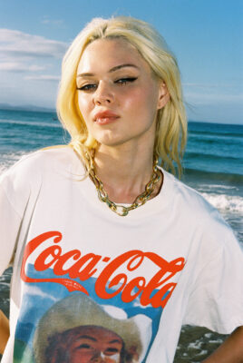 model ayla wearing coke shirt at beach