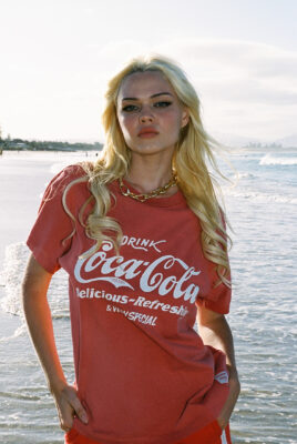 model ayla wearing coke shirt at beach