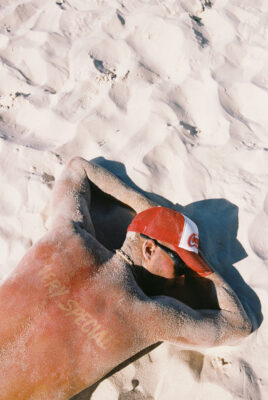 model bruno laying in sand with something very special sunburnt on back
