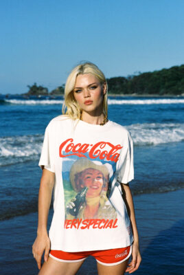 model ayla wearing coke shirt at beach
