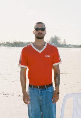 model bruno wearing coke x svs shirt at beach